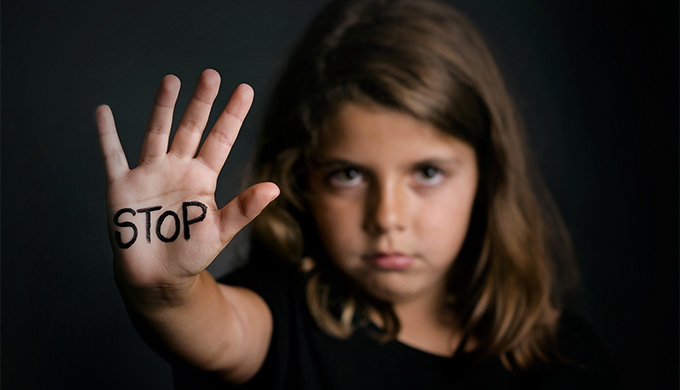 Photo d'une jeune fille levant la main pour dire stop